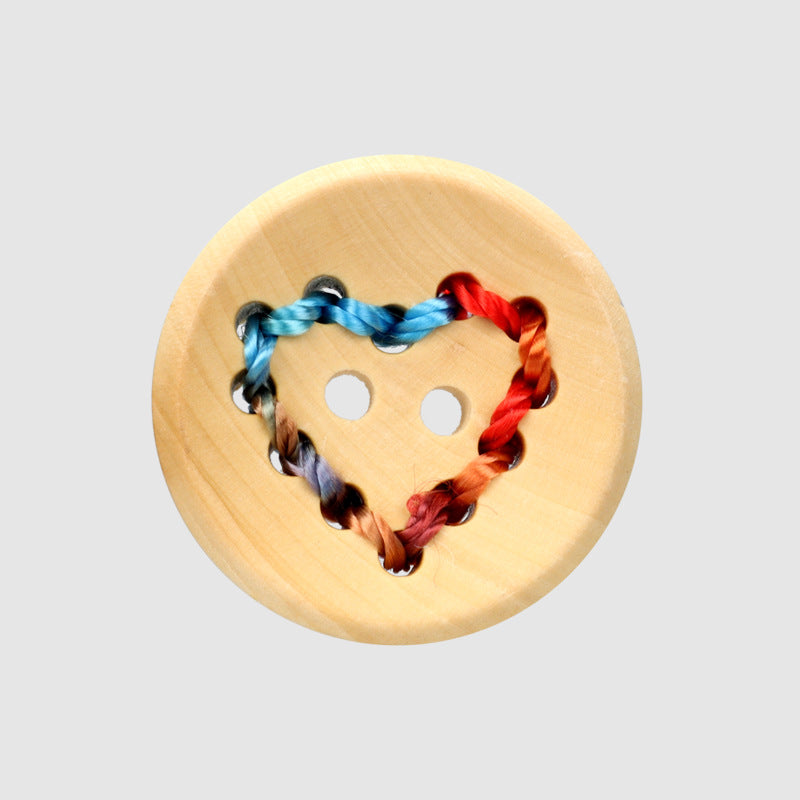 Light wood button with heart cutouts, stitched multicolor thread (blue/red)