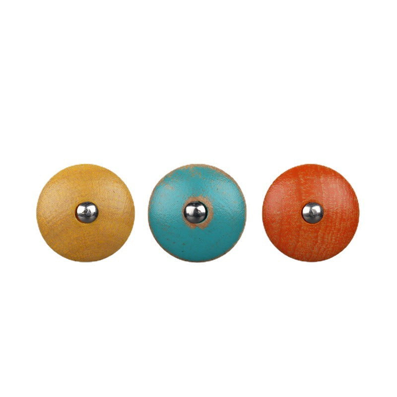 Three round wood buttons: tan, turquoise blue, and orange-red with metal shanks