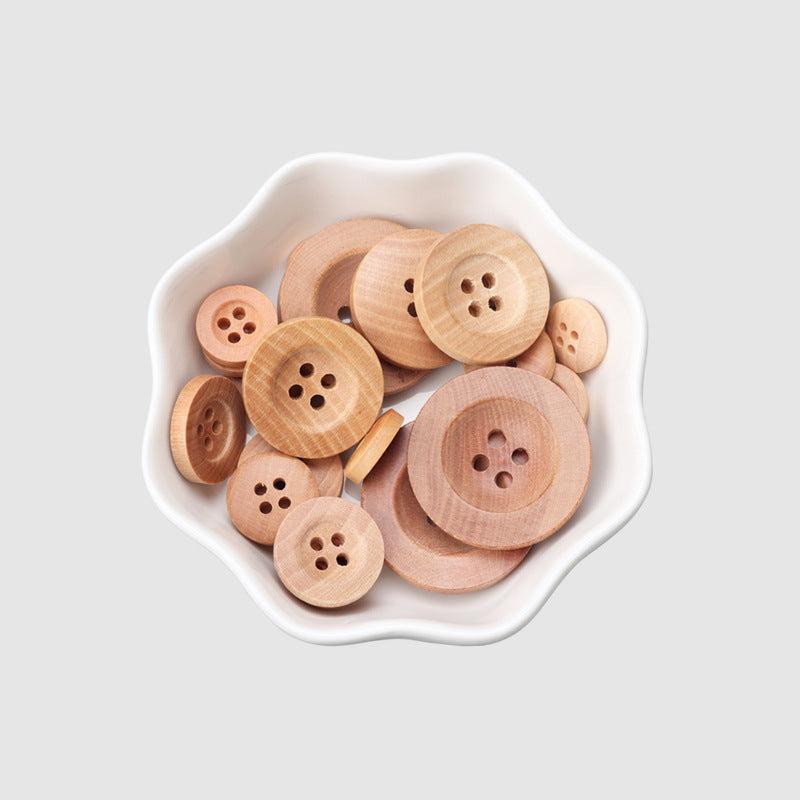 Natural camellia wood four-hole buttons, wide rim, in white dish (10–25mm)