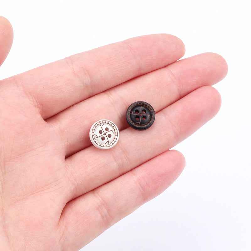 Round 4-hole buttons in hand: white front with brown pattern and dark back