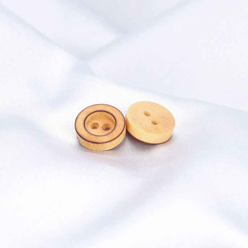 Two round poplar wood buttons, tan; one shows 2 holes, one shows the back