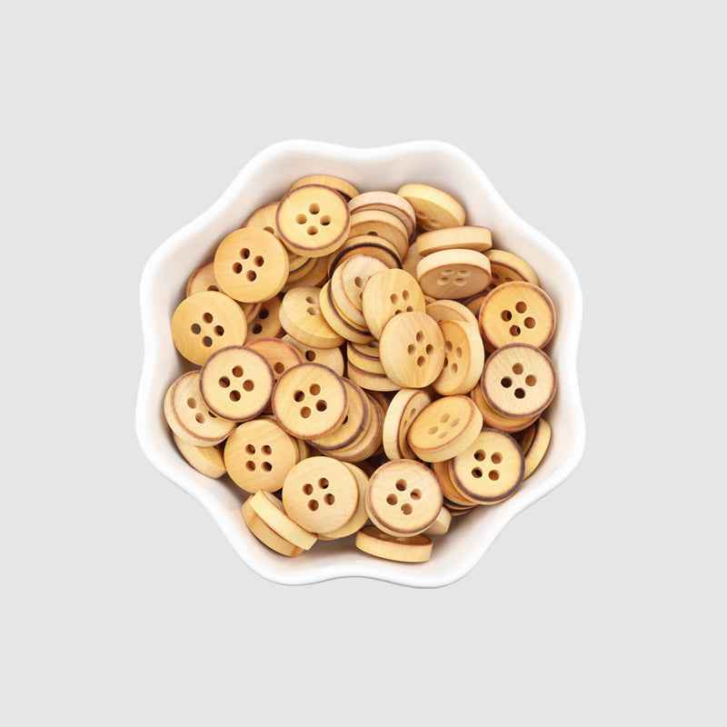 Round 4-hole poplar wood buttons, light brown, stacked in a bowl