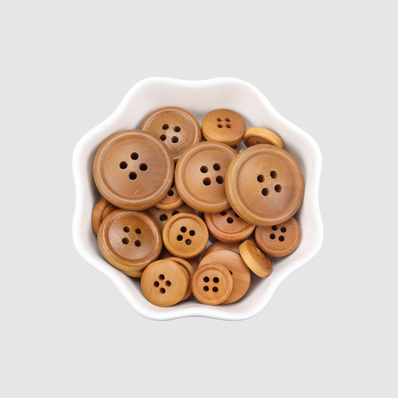 Assorted round 4-hole poplar wood buttons in bowl, warm brown tones.