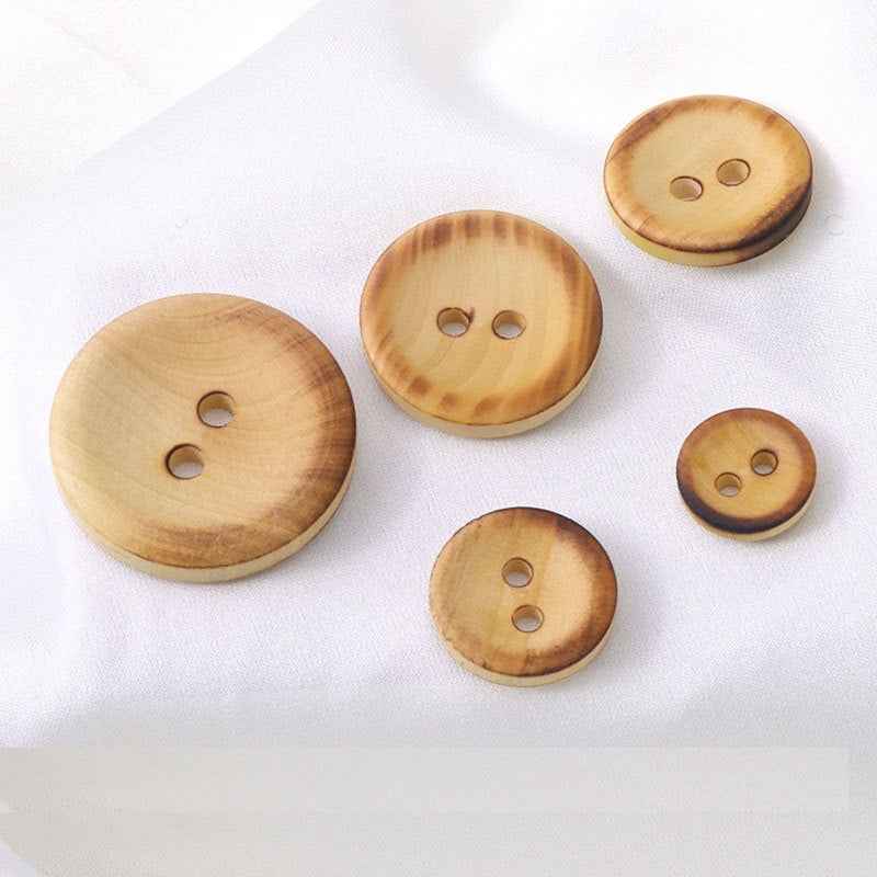 Set of round 2-hole fire-burned boxwood buttons in mixed sizes, light tan.