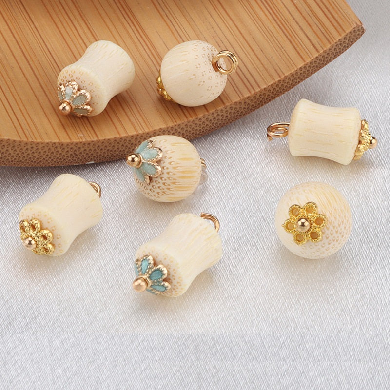 Assorted frog knot buttons: cream bamboo cylinders and rounds with gold mounts and teal/clear accents