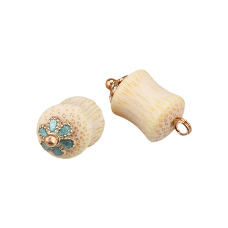 Cream bamboo frog knot button pair: round top with gold teal floral accent and a curved back ring