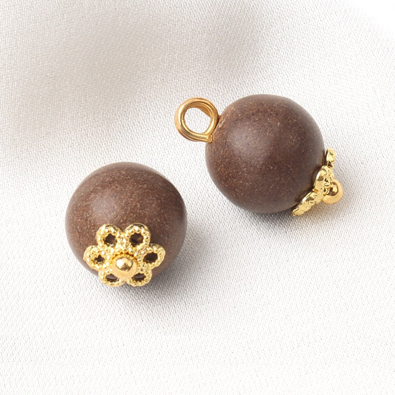 Khaki round coconut shell button with gold flower setting and metal shank loop