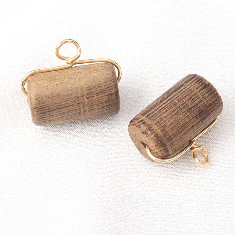 Wooden cylindrical button 22x13mm with gold-toned loop shank and striped wood grain