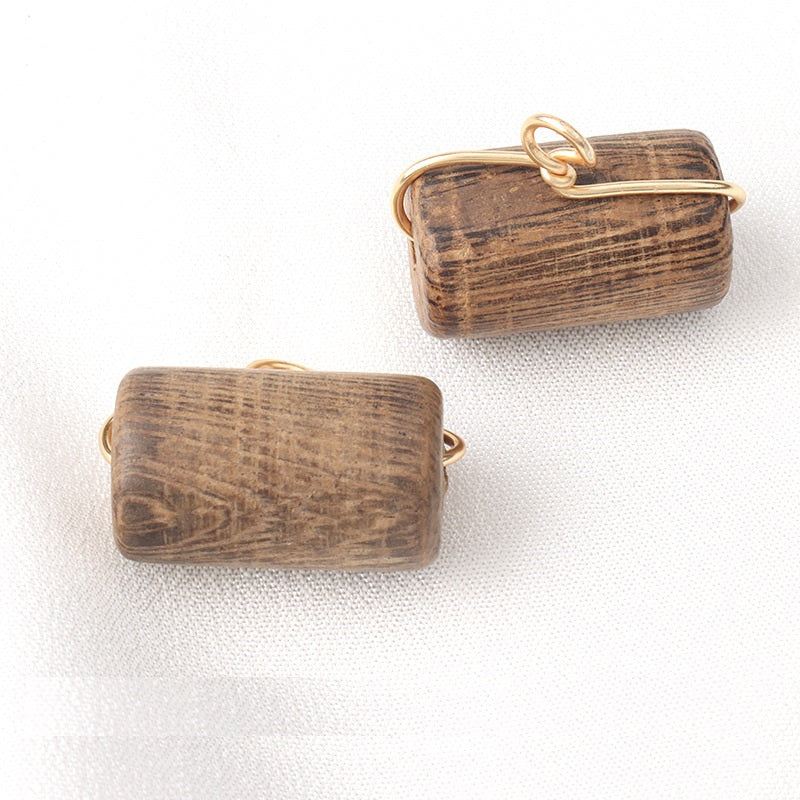 Wooden cylindrical buttons 22x13mm with gold-toned loop shanks, visible wood grain