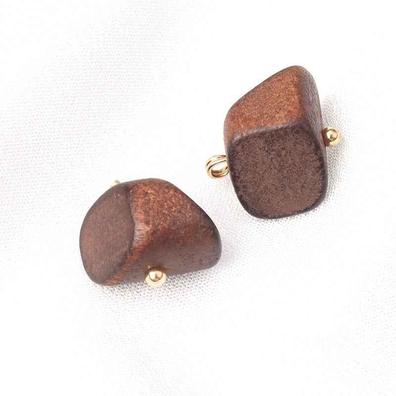 Two dark brown irregular trapezoid wood buttons with gold loop shanks