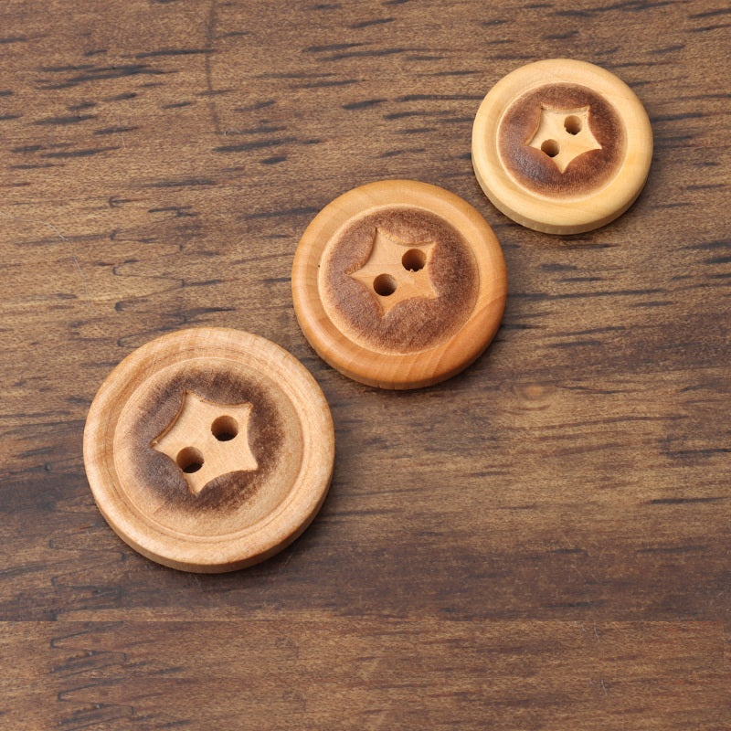Round poplar wood button with star pattern, two holes, fire-burned rim finish