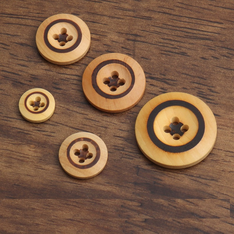 Assorted round poplar wood buttons with four holes and dark burned accents