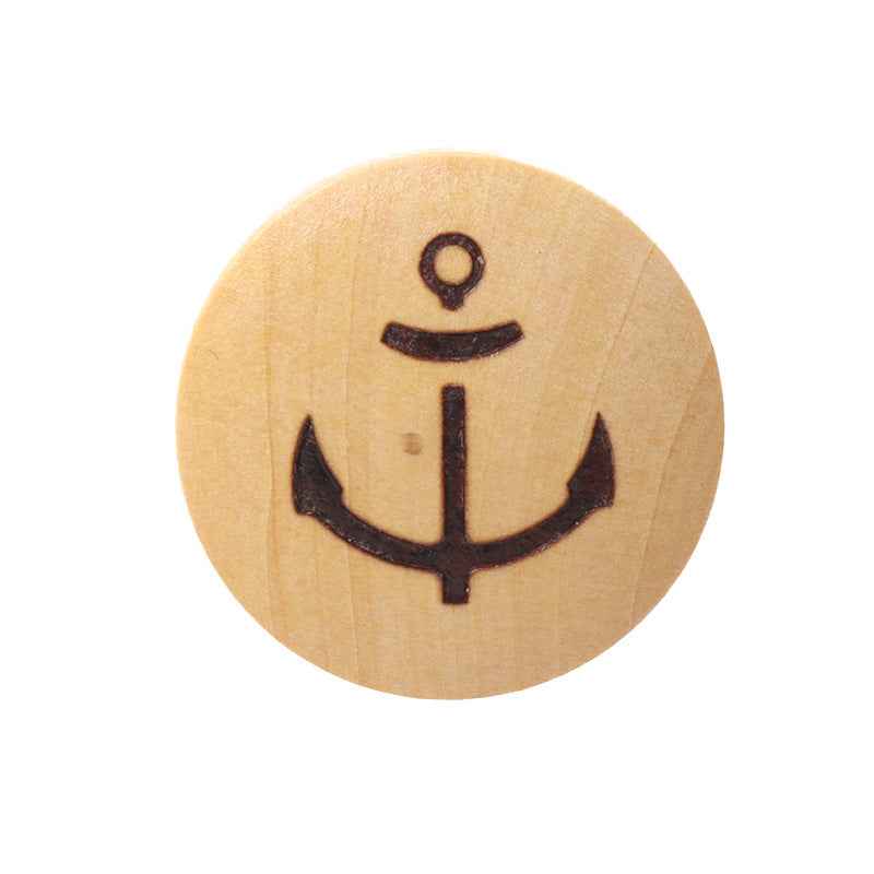 Light wood shank button with laser-engraved anchor design, dark outline