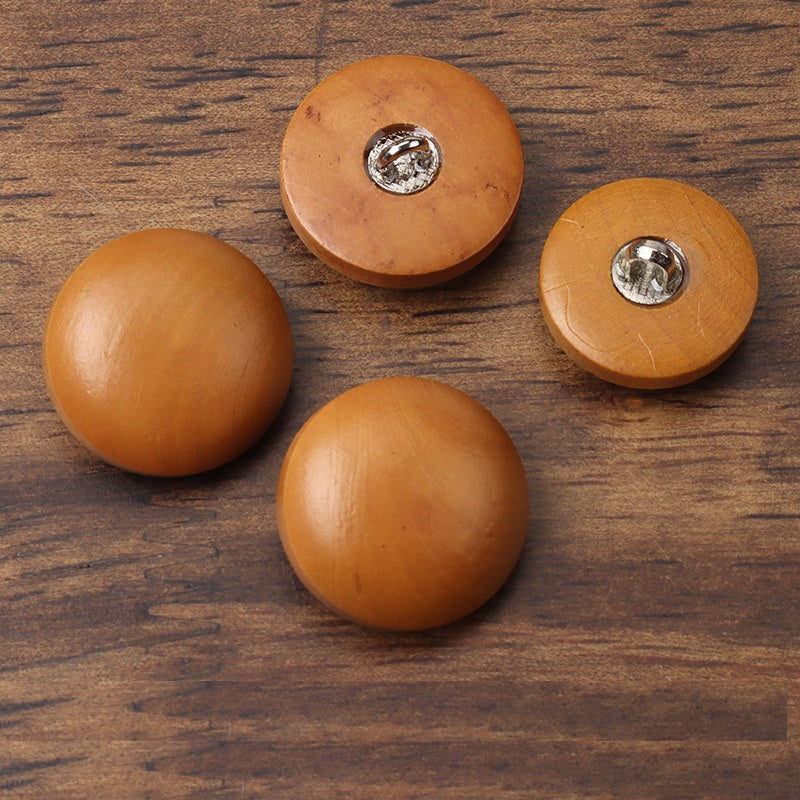 Set of round brown wood buttons with metal shank backs visible