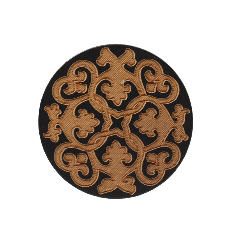 Round black flat wood button with golden laser-engraved floral filigree pattern