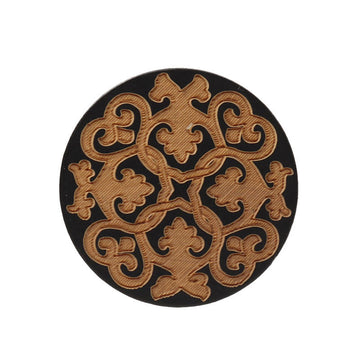 Round black flat wood button with golden laser-engraved floral filigree pattern