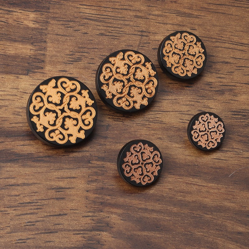 Set of black wood flat shank buttons with golden engraved filigree medallion pattern