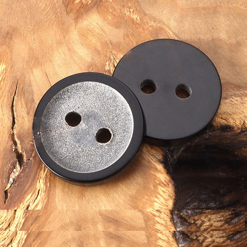 Round two-hole horn buttons, one gray speckled and one solid dark gray