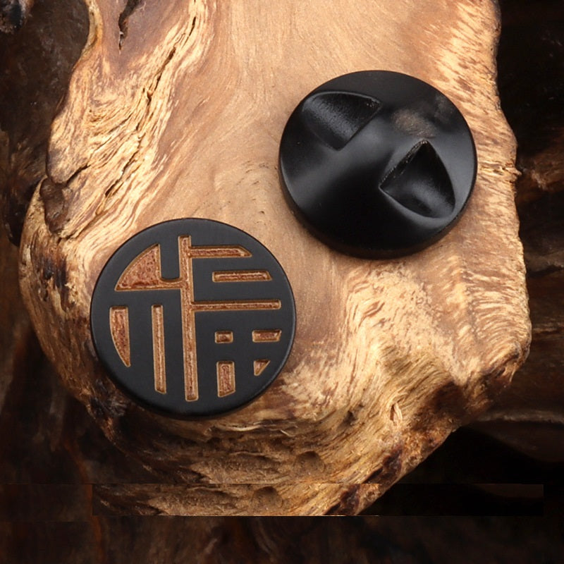 Round horn button showing front Chinese character engraving and matching back, dark