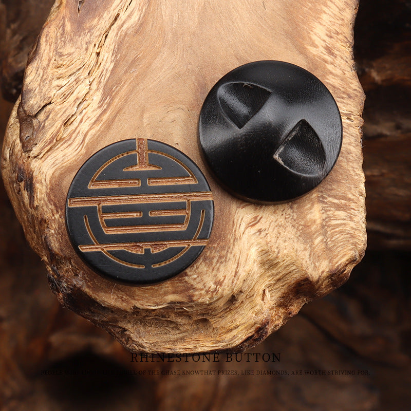 Round horn button with laser-engraved Chinese character, gold lines on dark horn