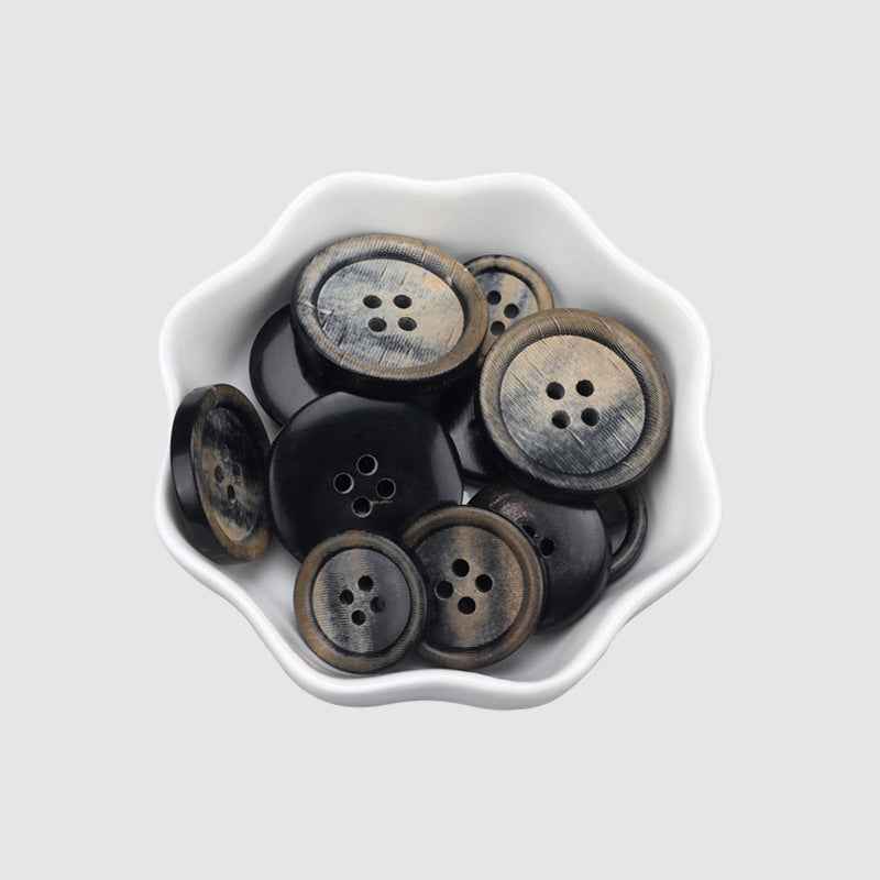 Horn button set in tray: dark black and gray, round, 4-hole designs