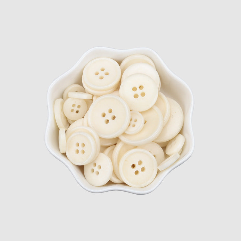 White 4-hole sweater buttons in a tray, 11.5–23mm vintage natural bone look