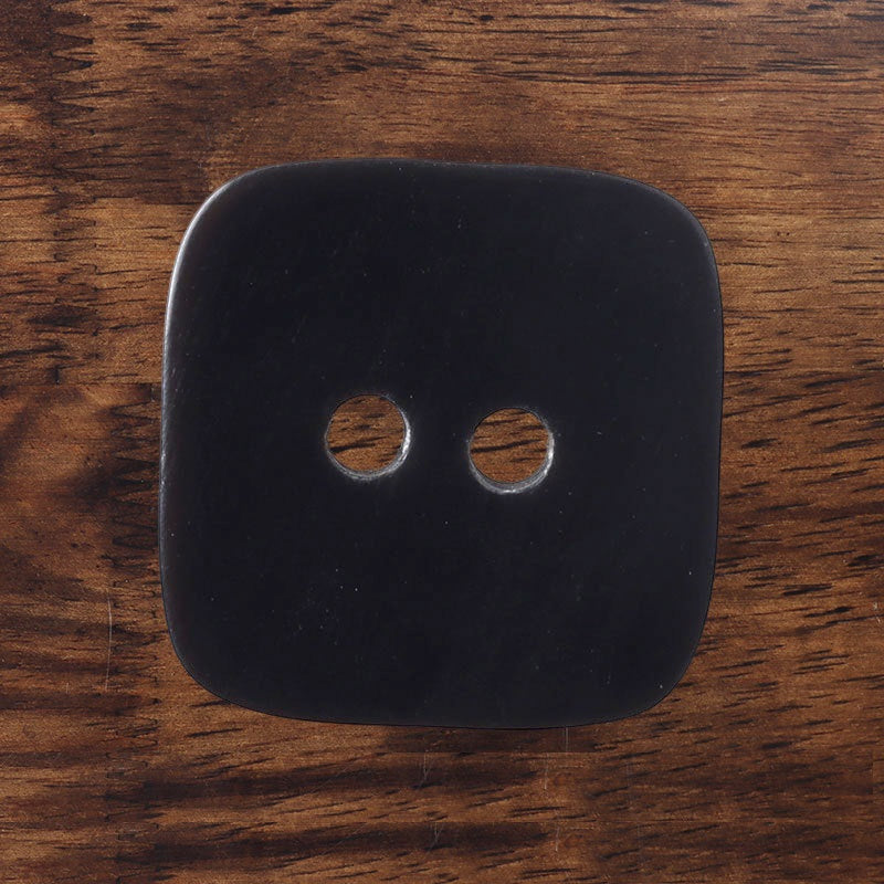 Square 2-hole horn button, dark finish with two circular holes