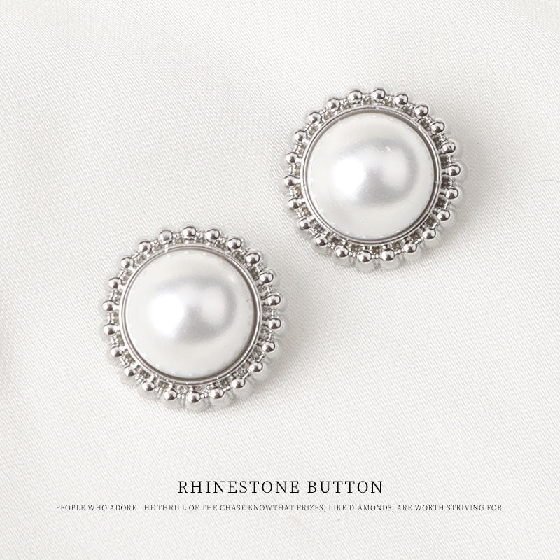 Two round silver metal pearl buttons with raised bead rim and glossy white center