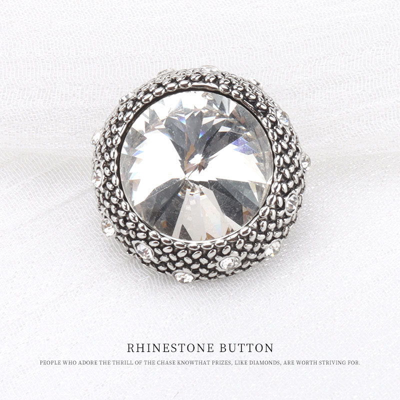 Silver round rhinestone button with clear faceted crystal center and bead-textured edge