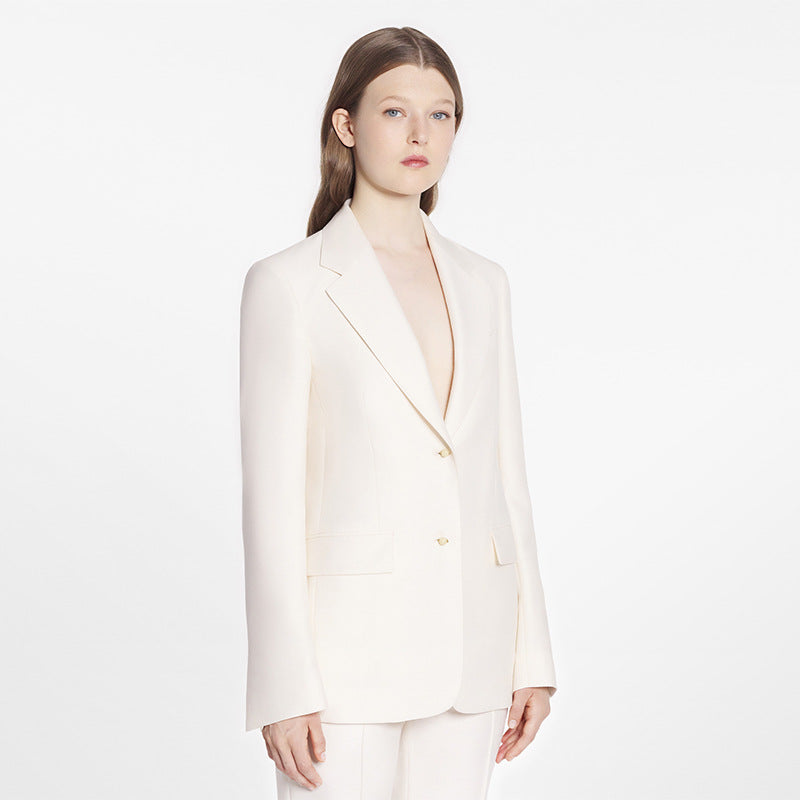 White blazer with small buttons visible on the front placket