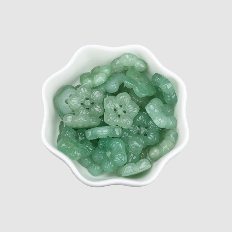 Light green jade petal flower buttons with four holes in a dish