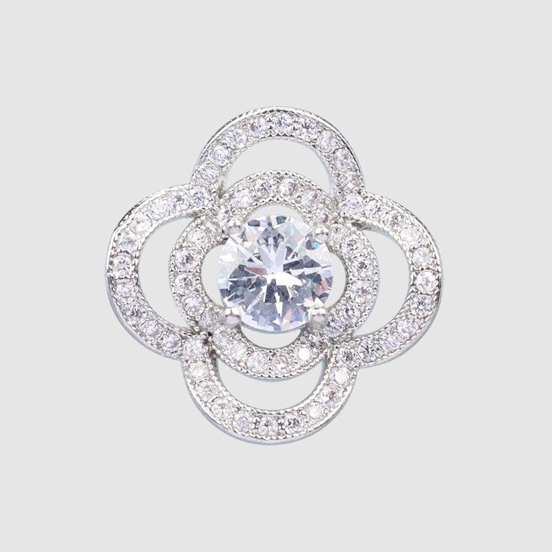 Silver-tone four-leaf clover button with sparkling halo and central round rhinestone