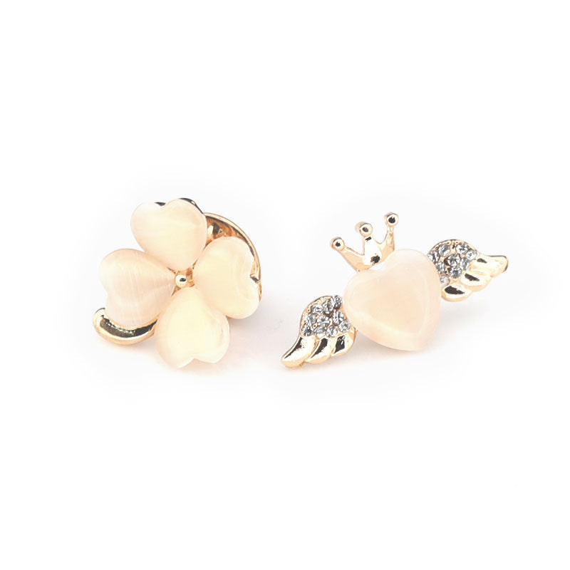 Golden cat brooches with white flower-like center and small rhinestone details