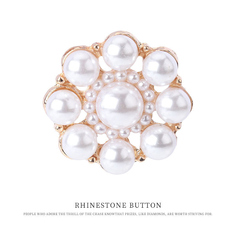 Gold-tone 23mm pearl button with raised white pearls and metal ring details