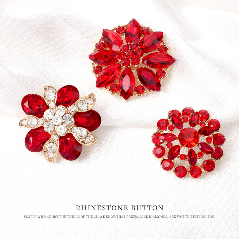 Three red rhinestone floral buttons with gold-tone frames, faceted crystal centers