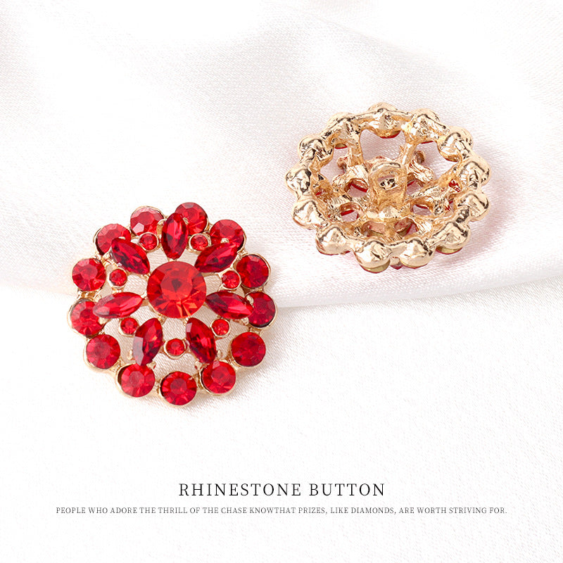 Red rhinestone floral button with gold-tone back, ornate filigree and settings