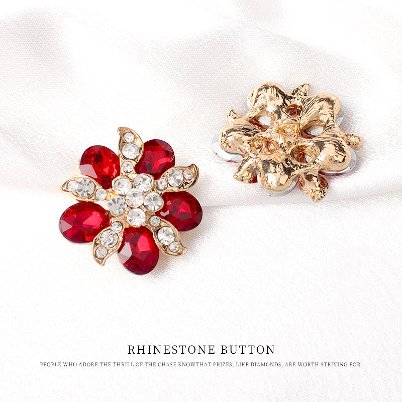 Red and clear rhinestone floral button with gold-tone back, ornate filigree setting
