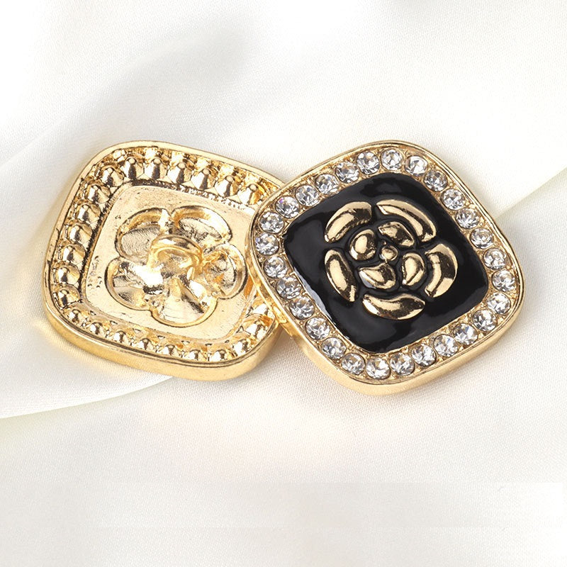 Square rhinestone button: black enamel flower center with gold-tone border; pair view
