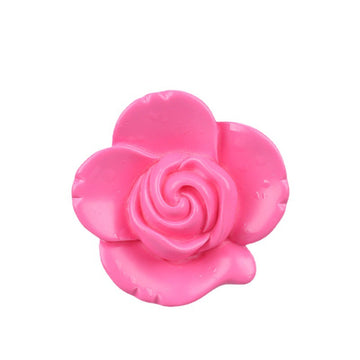 Rose-pink flower-shaped button with embossed swirl center