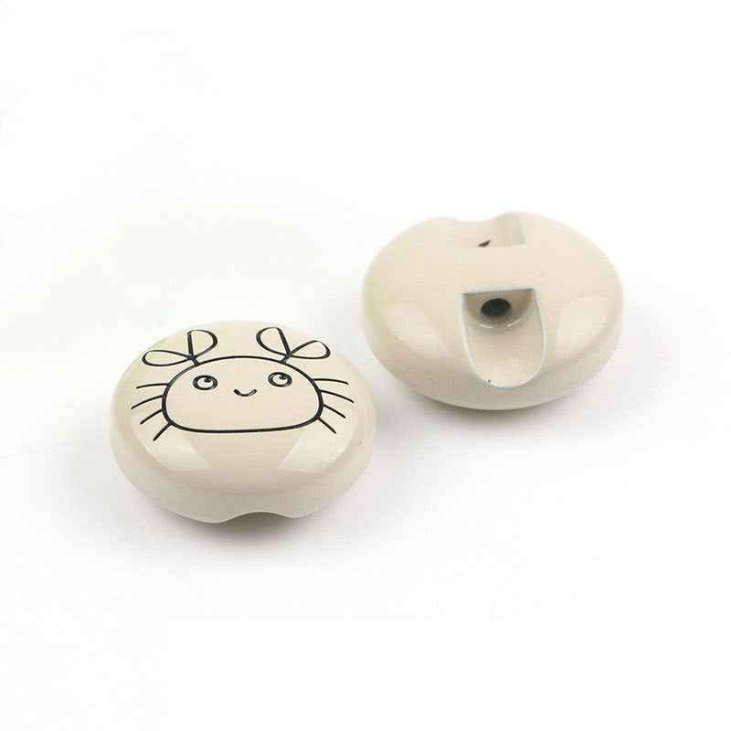 White animal cartoon button pair with green eye: front design and back with hole