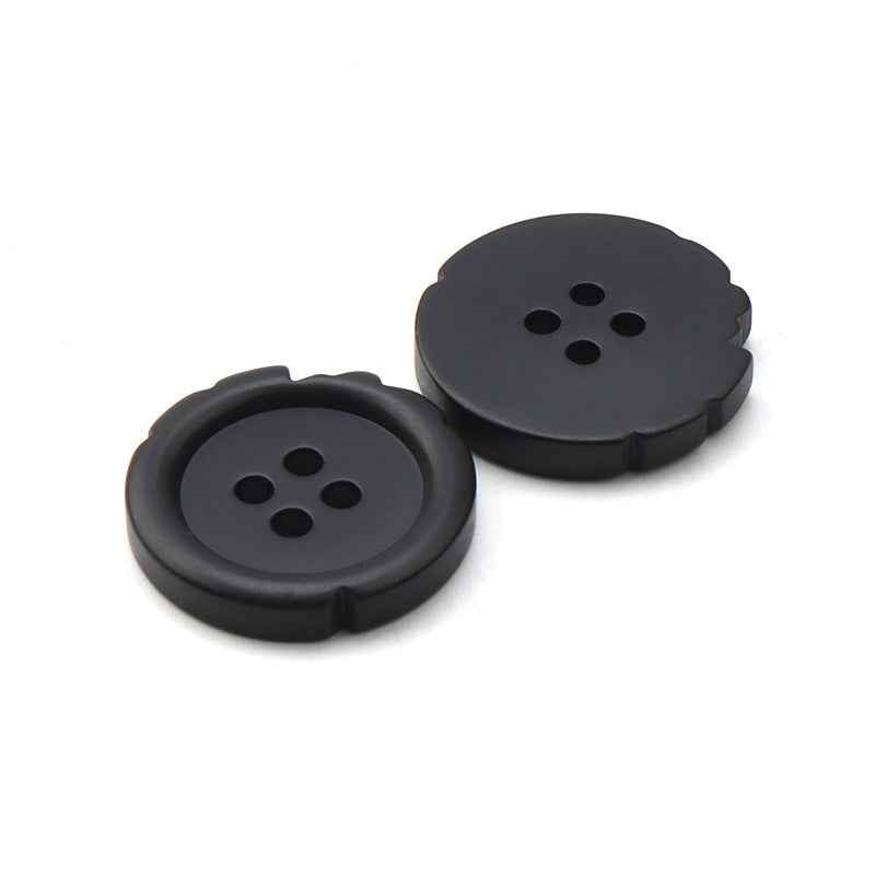 Two black resin suit buttons, four holes on flat round face