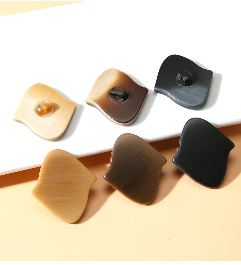 Irregular resin buttons with shanks, shown as dark, tan, and light-brown styles