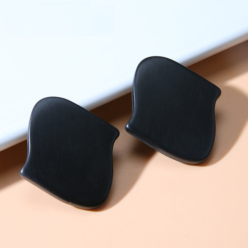 Black irregular resin buttons with shanks, matte curved shape, two pieces