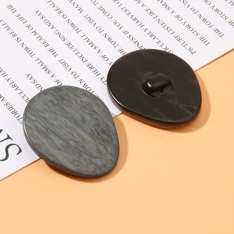 Oval wood-grain resin shank button, dark gray oval face with black shank back