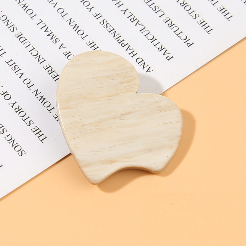 Beige heart-shaped resin shank button with wood-grain texture