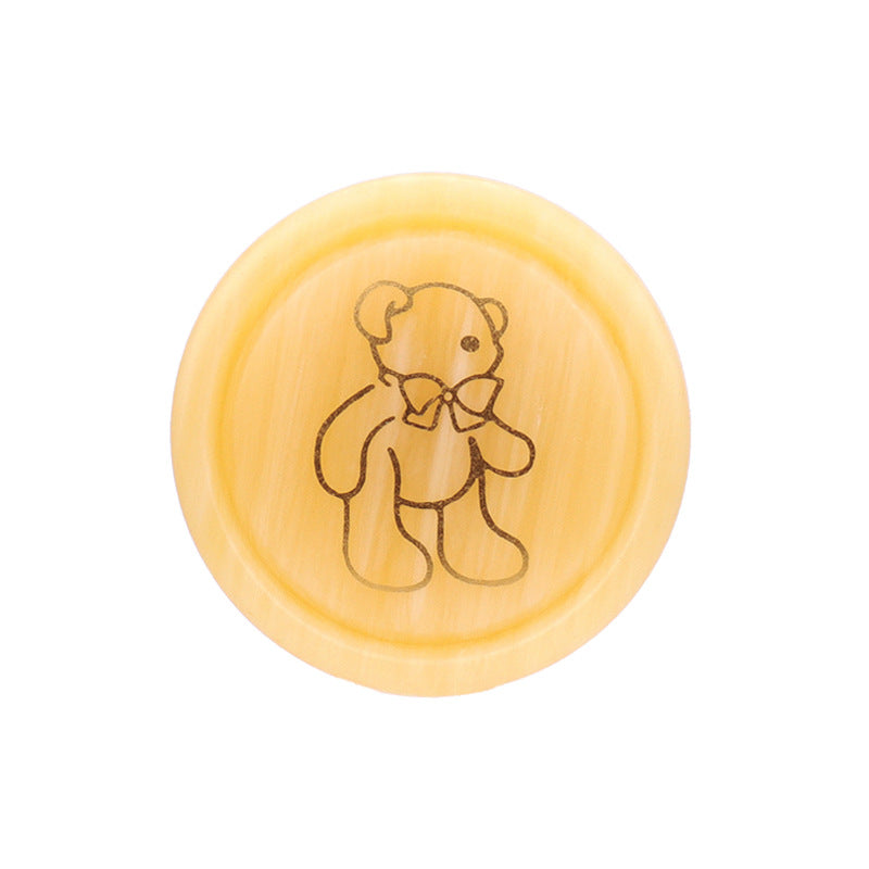 Round resin shank button, beige yellow with teddy bear line drawing