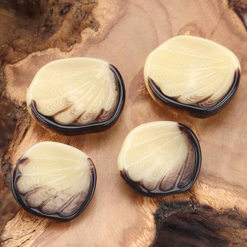 Cream shell-look coat buttons, swirling pattern with dark rim, 4 shown