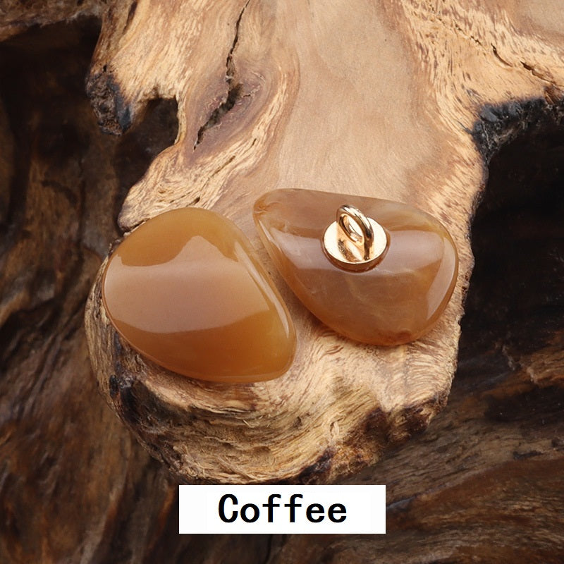 Two resin-look jade buttons with gold-tone metal loops, caramel and beige teardrops