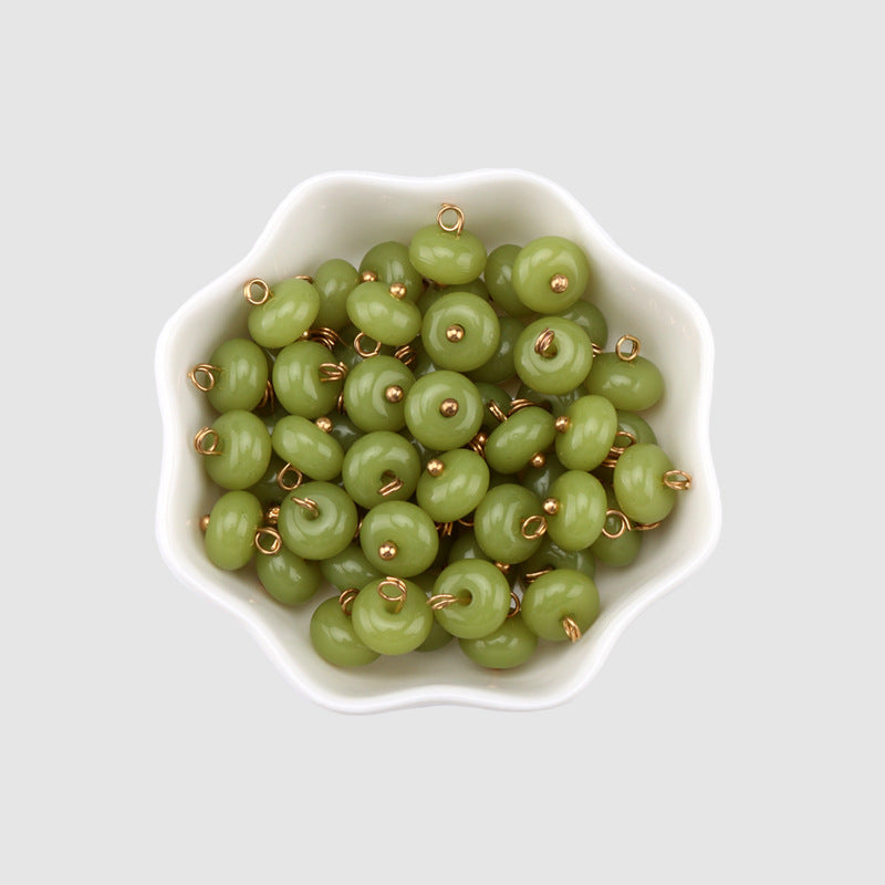 Grass-green 10mm resin buttons, round domed faces with gold shanks (multiple in bowl)