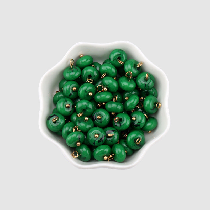 Green 10mm resin buttons, round domed faces with gold shanks (multiple in bowl)